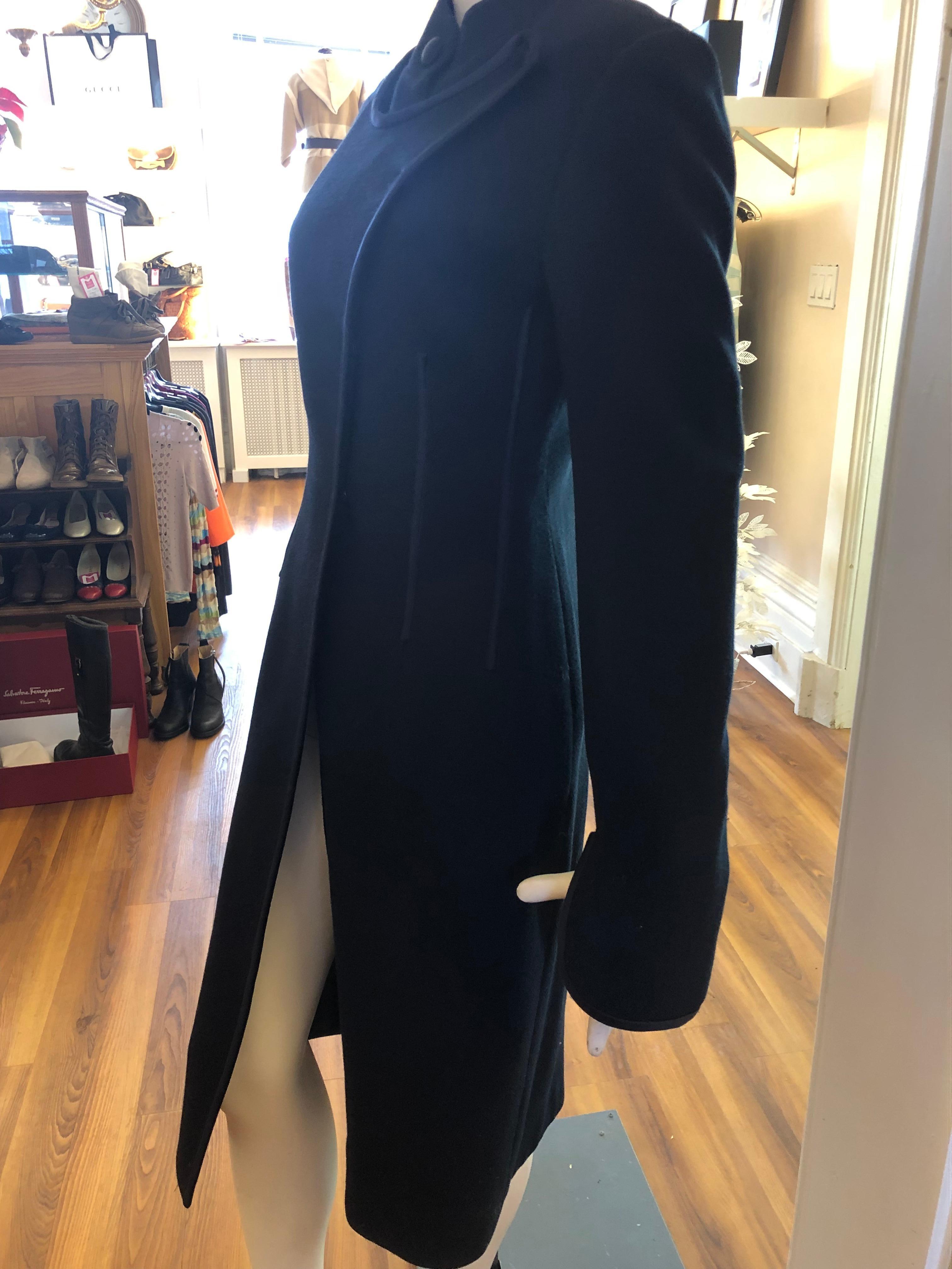 This gorgeous Celine coat is in fantastic condition, made of wool with navy blue satin piping. A distinguishing feature of this coat is the bib insert which is shown in the photographs, as well as the unusual sleeves.