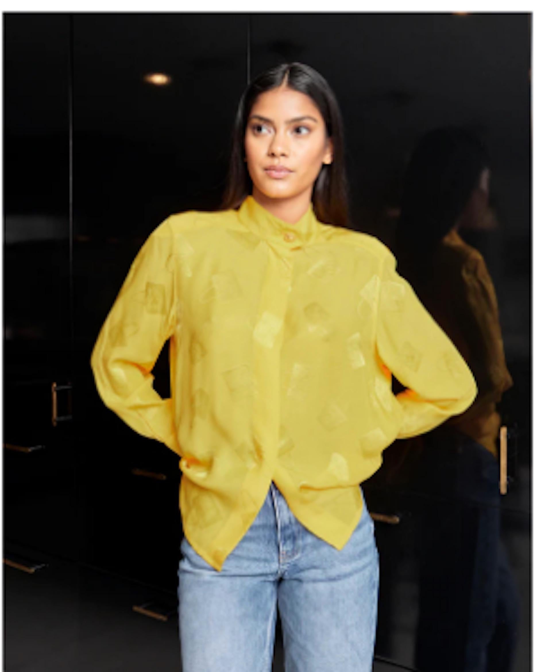 VINTAGE GRACE NY

1980s Celine button-down yellow blouse featuring subtle purse print and large gold button at collar. Lightly padded shoulders. 100% silk.  Excellent Vintage Condition. 

Shoulders 16 in
Bust up to 40 in
Waist 40 in
Sleeve 23