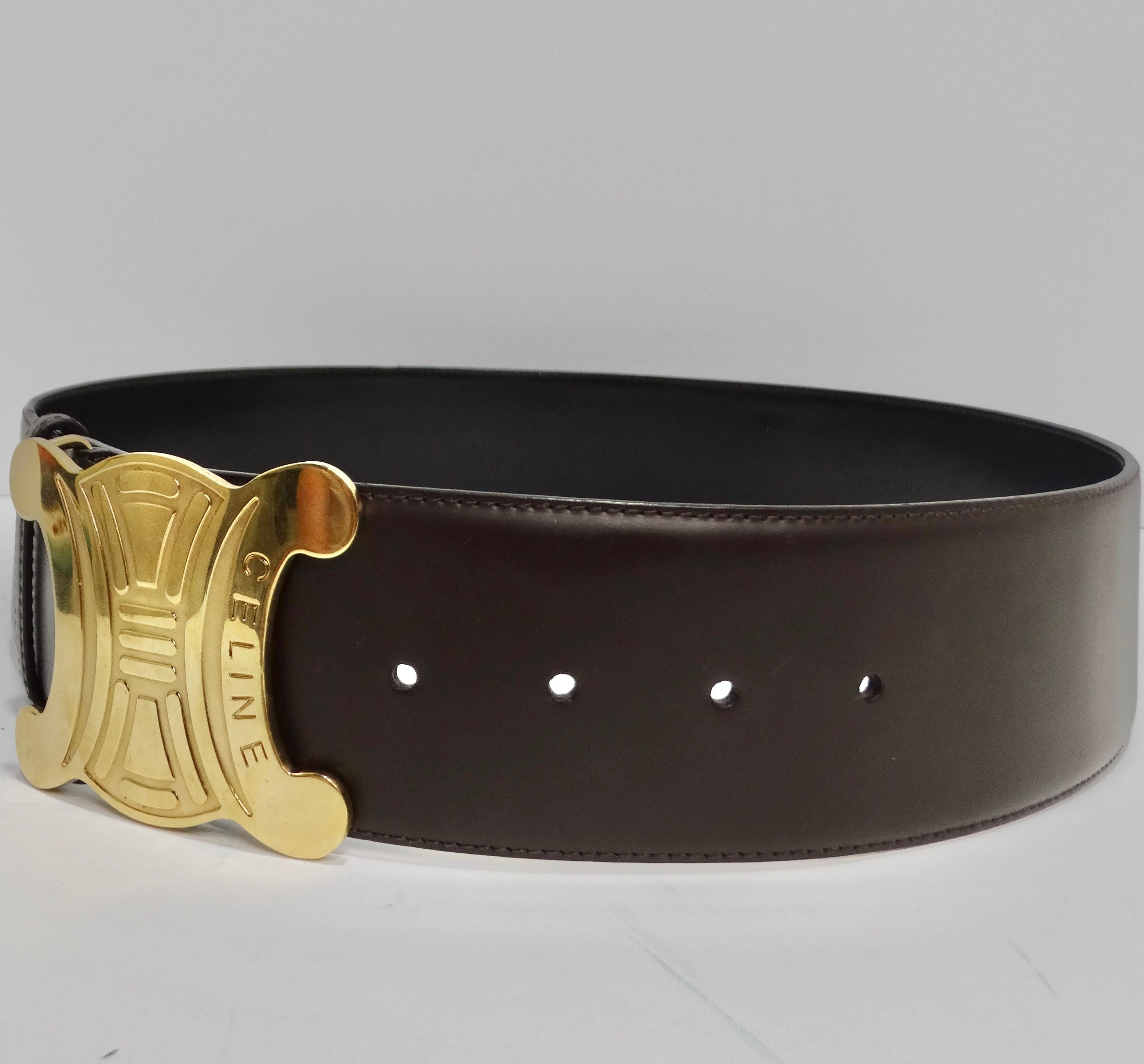 Elevate your wardrobe with this iconic Celine 1990s Brown Leather Gold Tone Belt. Crafted from rich, deep brown leather, this belt exudes timeless sophistication. The true highlight is its striking gold tone buckle, proudly displaying the Celine