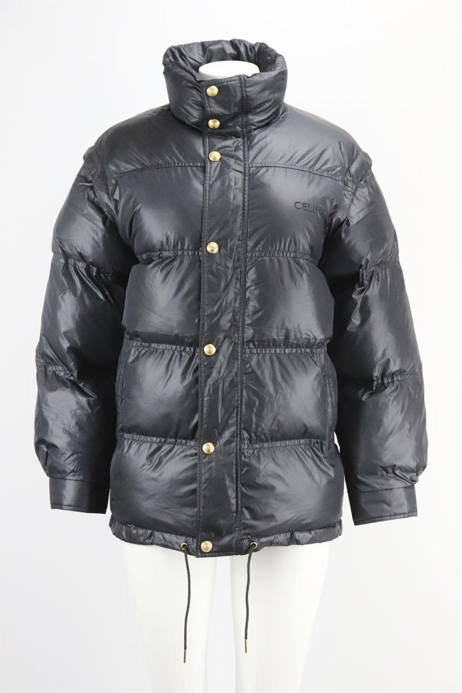 Celine 2022 oversized logo embroidered quilted shell down jacket. Black. Long sleeve, mock neck. Zip fastening at front. 100% Polyamide; lining: 100% polyamide; filling: 100% polyester. Size: FR 34 (UK 6, US 2, IT 38). Shoulder to shoulder: 18 in.