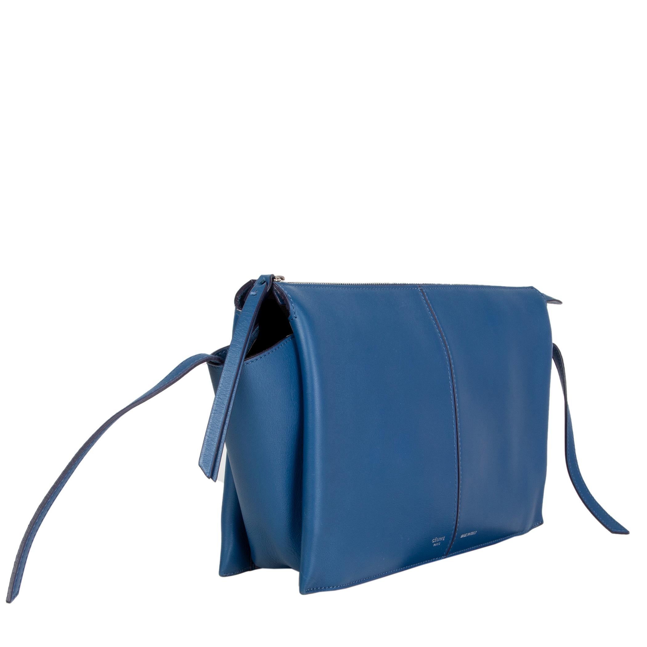 Céline ' Tri-Fold' clutch in aqua blue smooth and supple calfskin with winged sides. Opens with a zipper on and is divided in three compartments with two slip pockets and a zipper pocket. Unlined. Has been carried and is in excellent condition.