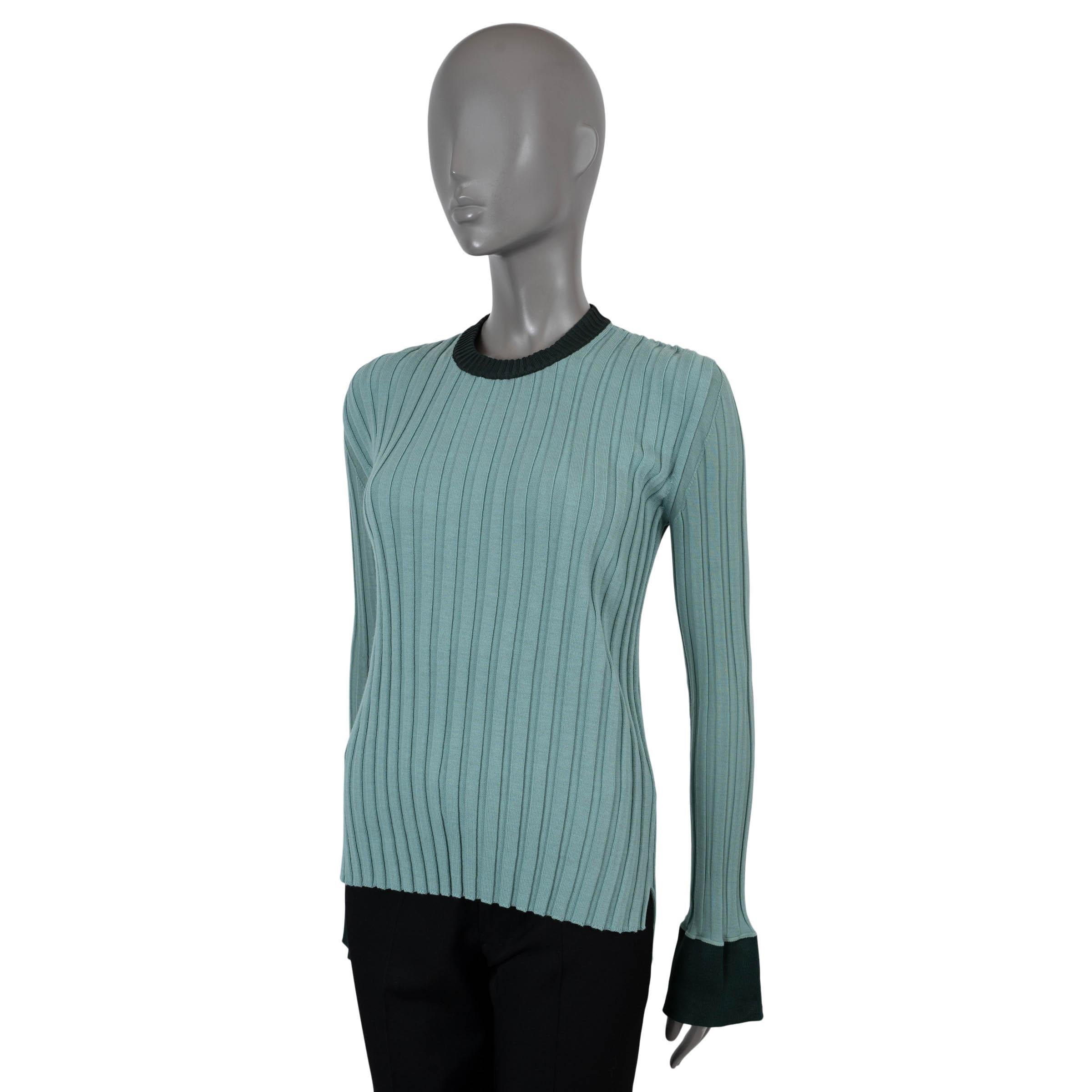 100% authentic Céline by Phoebe Philo sweater in aqua rib-knit wool (77%) and polyamide (23%). Features long sleeves with bell cuffs in bottle green jersey and a slightly longer back. Has been worn and is in excellent condition. 

2015