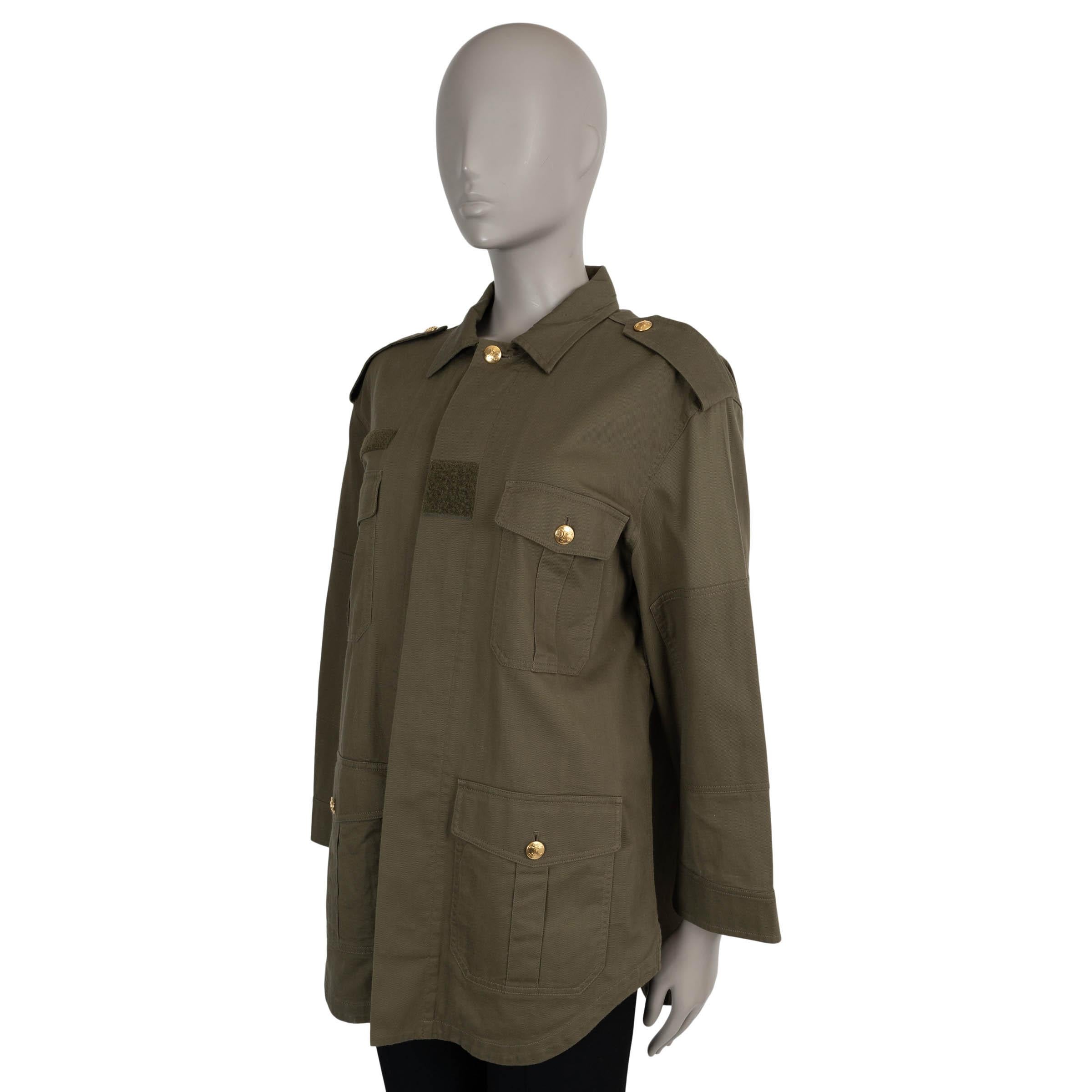 Questa giacca Celine Saharienne in twill di cotone verde militare, autentica al 100%, combina uno stile utilitario con dettagli di alta moda. Caratterizzata da una vestibilità oversize, un classico colletto a camicia e spalline abbottonate, questa