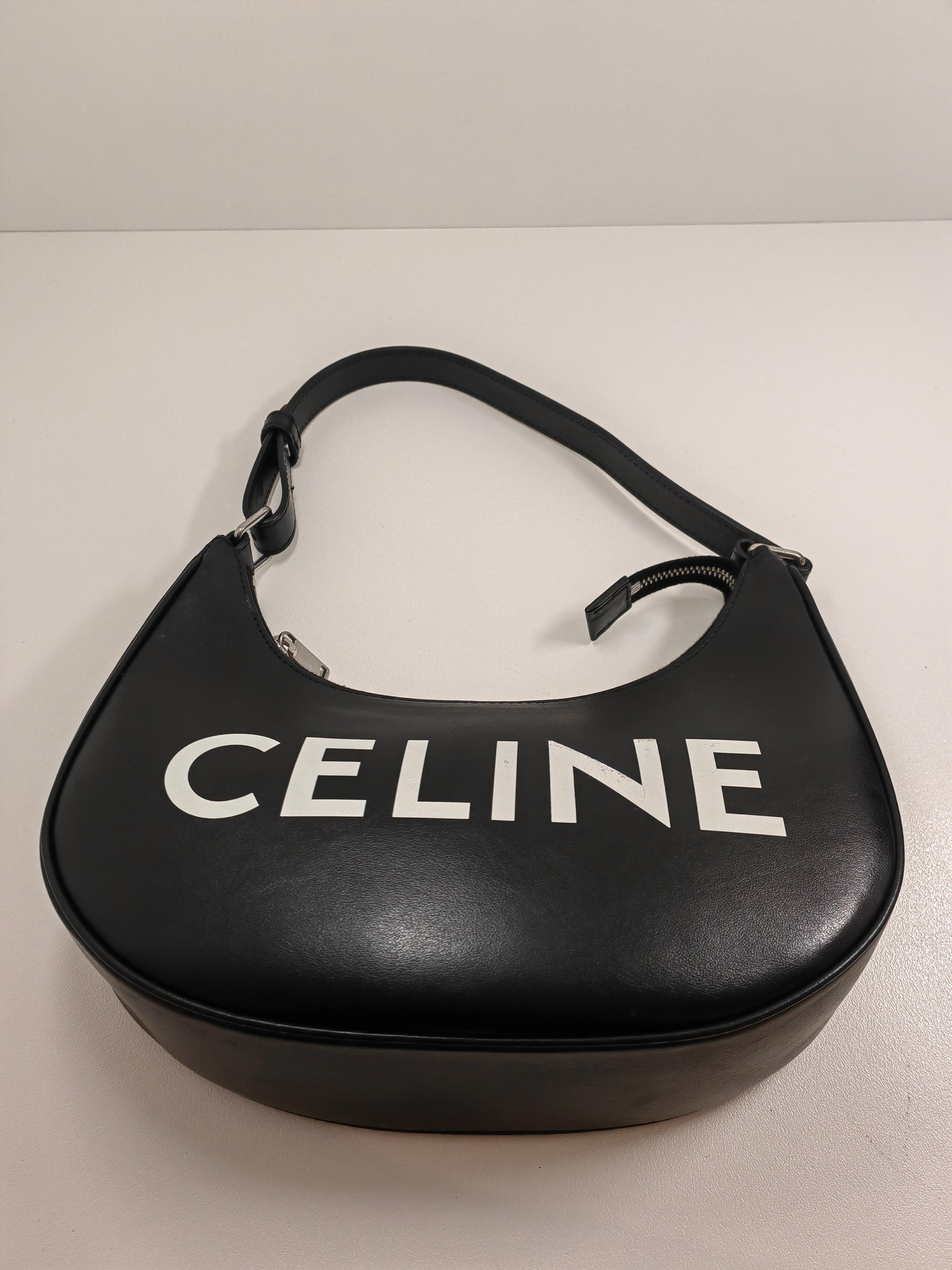 Celine
2021 Ava Logo Bag

Description
Celine Shoulder Bag
From the Fall 2021 Collection by Hedi Slimane
Black Leather
Graphic Print
Silver-Tone Hardware
Single Shoulder Strap
Suede Lining & Single Interior Pocket
Zip Closure at