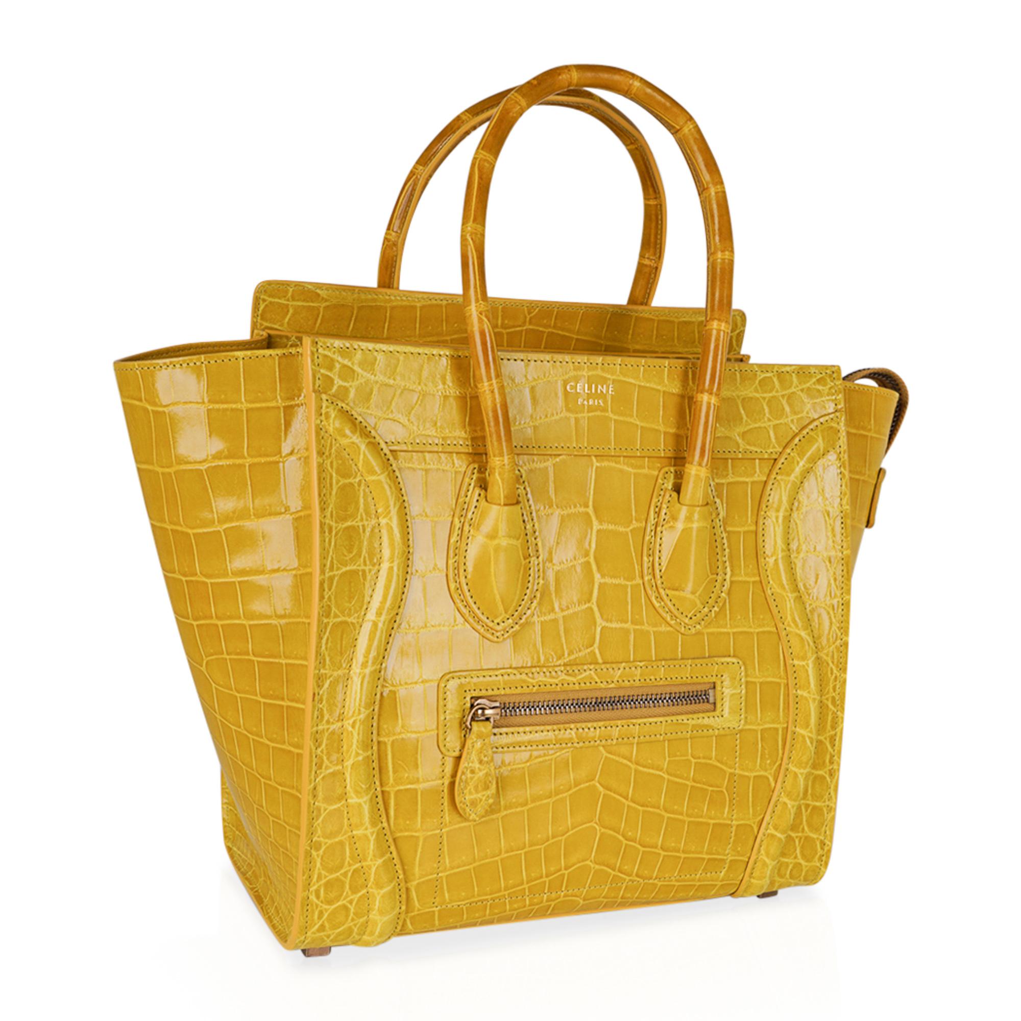 Guaranteed authentic Celine Yellow Micro Luggage tote featured in rare Yellow Crocodile skin.
An iconic beauty and one of the most sought after bags.
Zip top with 2 interior slot pockets and 1 zip pocket.
1 exterior zip pocket.
4 metal feet.
CELINE