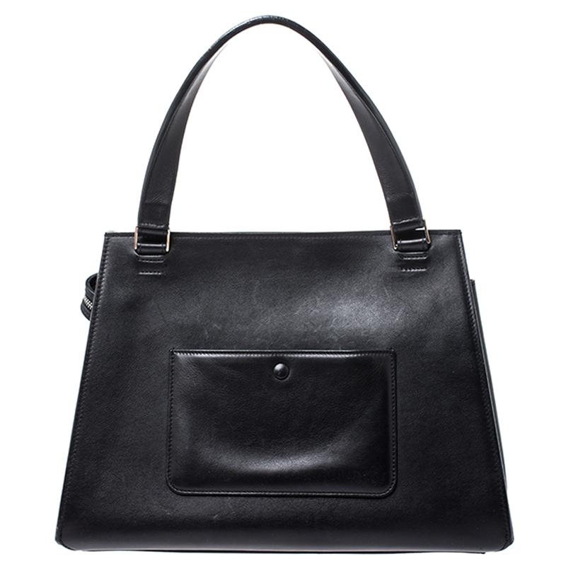 This Celine Edge bag is not only visually magnificent but also functional. It has been crafted from leather and styled with a silhouette that is classy and posh. The beige bag has a top handle and a top zipper that reveals a spacious interior. The