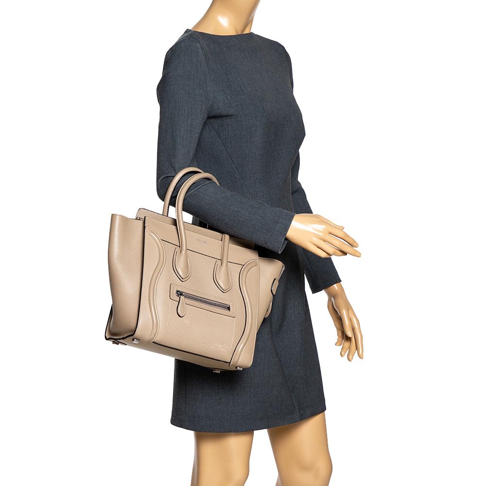 The micro Luggage tote from Celine is one of the most popular handbags in the world. This tote is crafted from leather and designed in a beige shade. It comes with rolled top handles and a front zip pocket. The bag is equipped with a well-sized