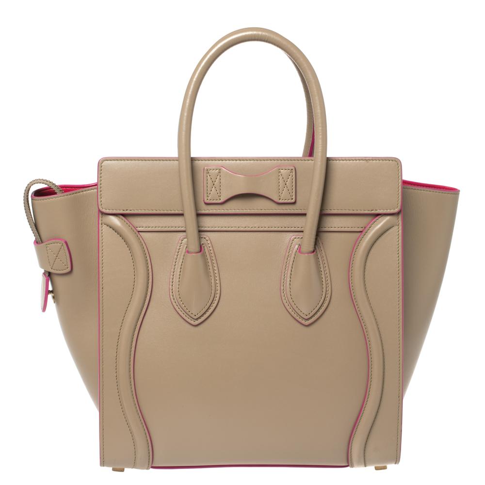 This Celine Luggage tote is stylish and perfect for everyday use. Crafted from leather in a versatile beige hue, it features the signature flappy wings, double rolled handles, and a front zip pocket. The top zip closure opens to a perfectly sized