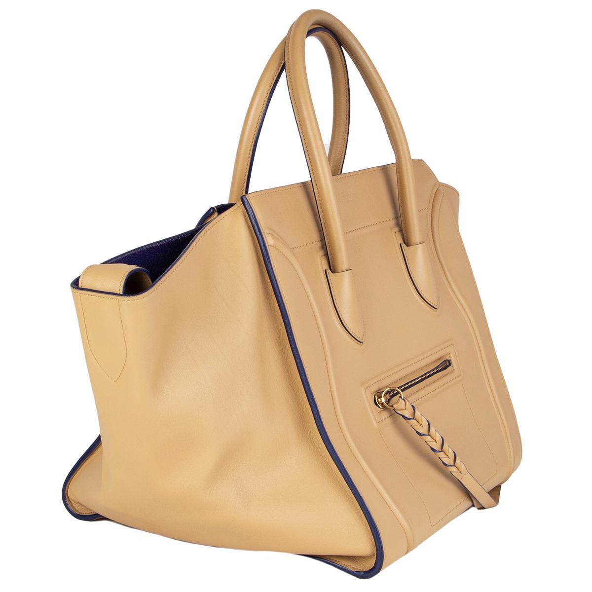 Céline 'Medium Luggage Phantom' tote bag in sand calfskin featuring a small zip front pocket. Lined in royal blue suede with one zipper pocket against the back. Has been carried with some faint darkening to the corners. Overall condition is
