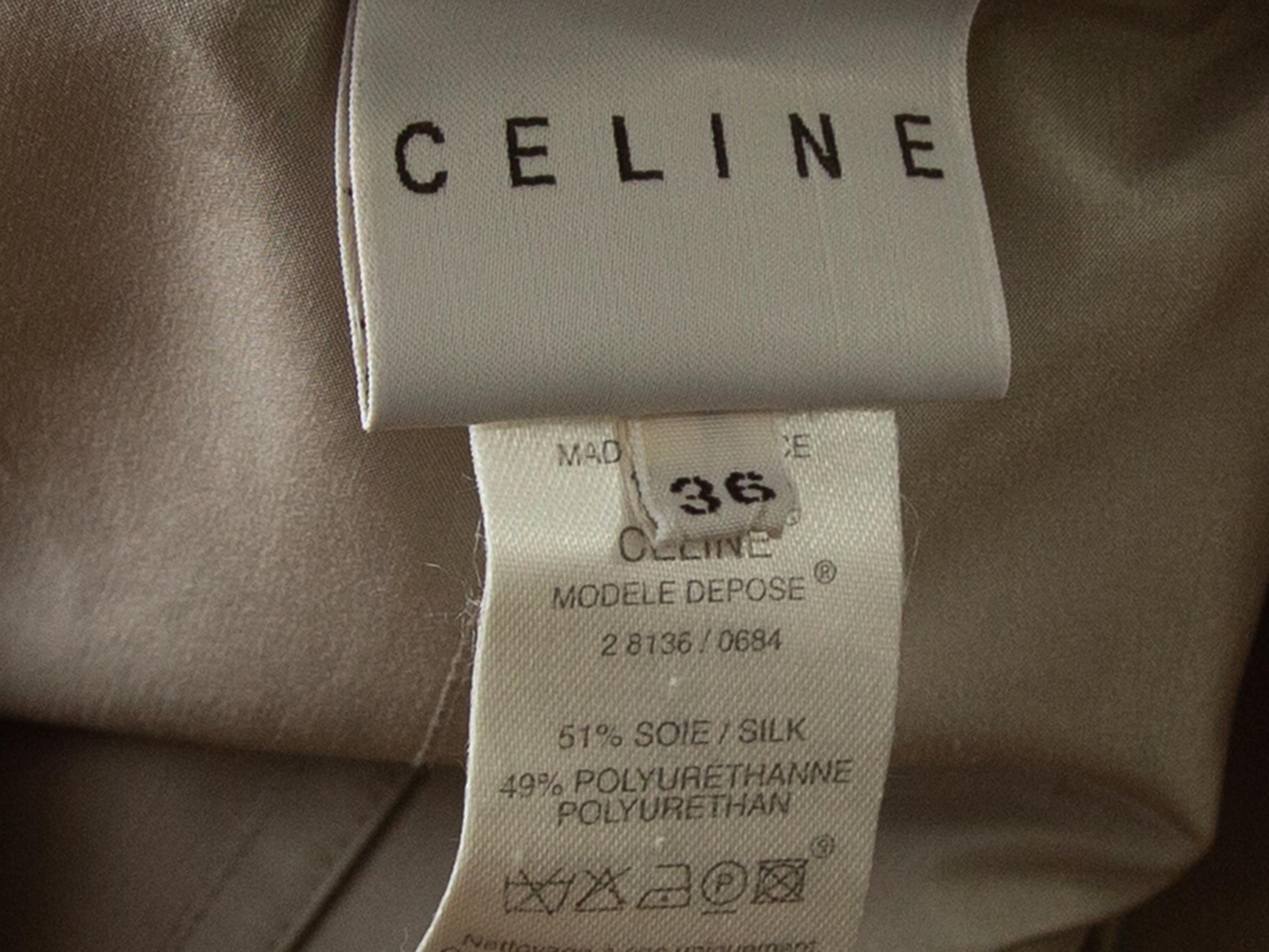 Product details: Beige long trench coat by Celine. Gold-tone zipper detailing throughout. Dual hip pockets. Button and belt closures. Designer size 36. 38