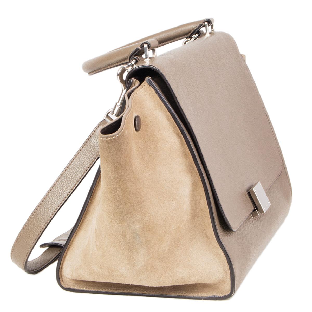 100% authentic Céline Small Trapeze bag in light beige suede and taupe grained leather. Zipper pocket on the outside back. Opens with a lock and a zipper on top. Lined in brown leather with two open pockets against the back. Has a detachable