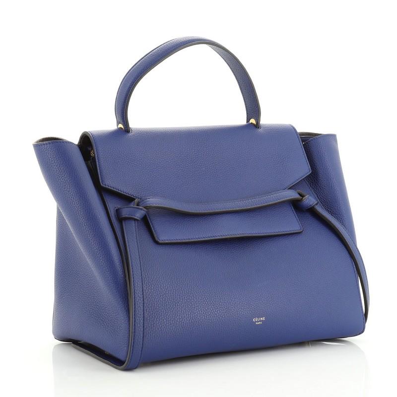 This Celine Belt Bag Grainy Leather Mini, crafted from blue grainy leather, features single looped top handle, exterior back zip pocket, and gold-tone hardware. Its top zip closure opens to a blue suede interior. 

Estimated Retail Price: