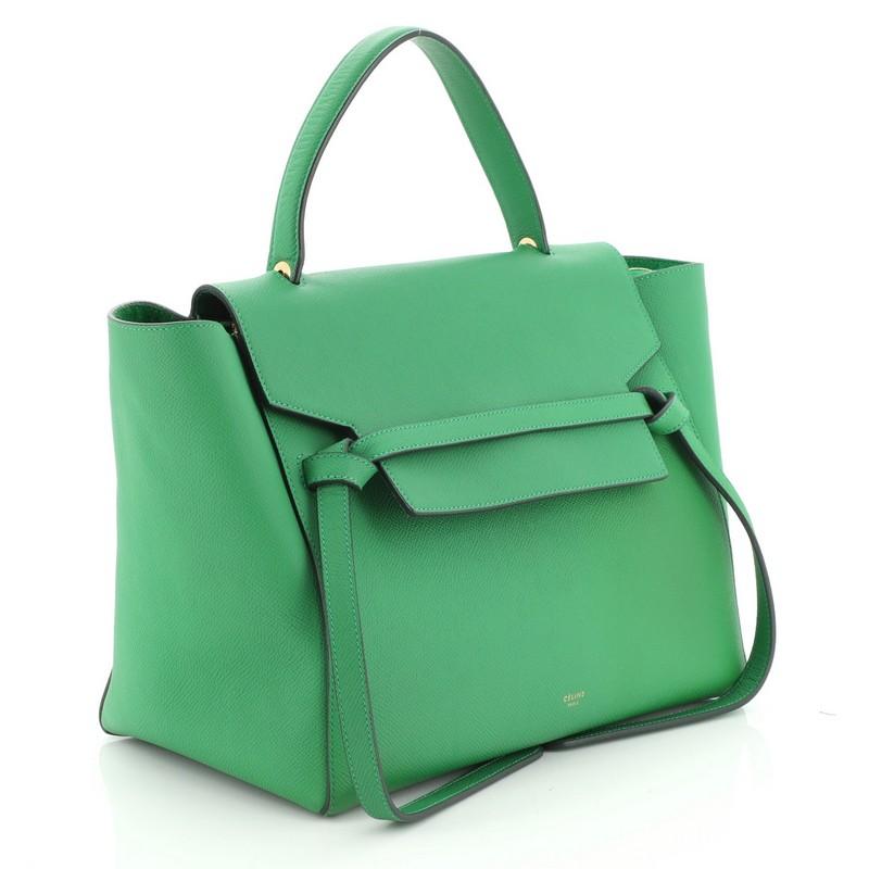 This Celine Belt Bag Textured Leather Mini, crafted from green textured leather, features single looped top handle, top flap slide closure, exterior back zip pocket, and gold-tone hardware. Its top zip closure opens to a green suede interior with