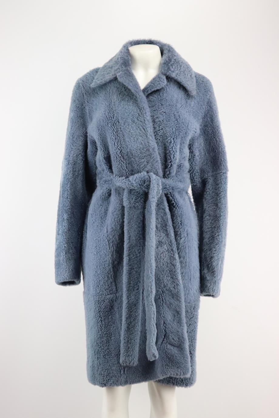 Celine belted shearling coat. Blue. Long sleeve, v-neck. Tie fastening at front. 100% Shearling. Size: FR 38 (UK 10, US 6, IT 42). Shoulder to shoulder: 17 in. Bust: 42.3 in. Waist: 45 in. Hips: 51 in. Length: 38 in Very good condition - As new
