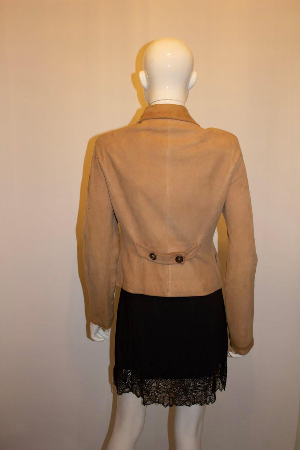 A super soft suede jacket by Celine. The jacket has a round collar  and button front, with button detail at the back. It is fully lined and made in France.
Size 38 Measurements: Bust up to 36'', length 22''
