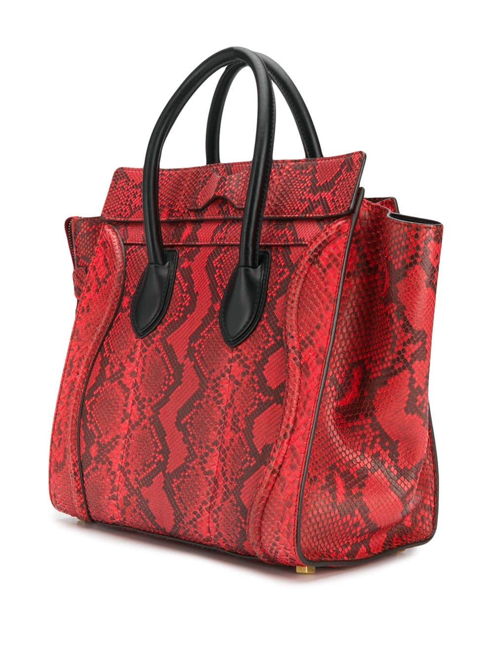 This Céline Mini Luggage bag is expertly crafted from red skin and finished with beautifully soft black leather, a must-have! The very rare distinctive Céline design features one exterior zipped pocket and a spacious main compartment inside. This is