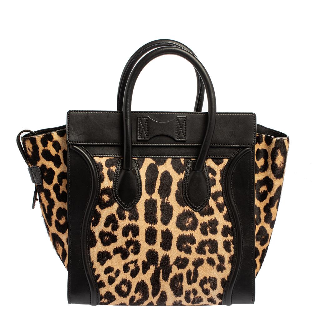 This trendy Mini Luggage Tote from Celine is a popular design. The tote is crafted from calf hair & leather and features a classy animal print with the signature flappy wings. It comes with rolled top handles, a front zip pocket, and bronze-tone