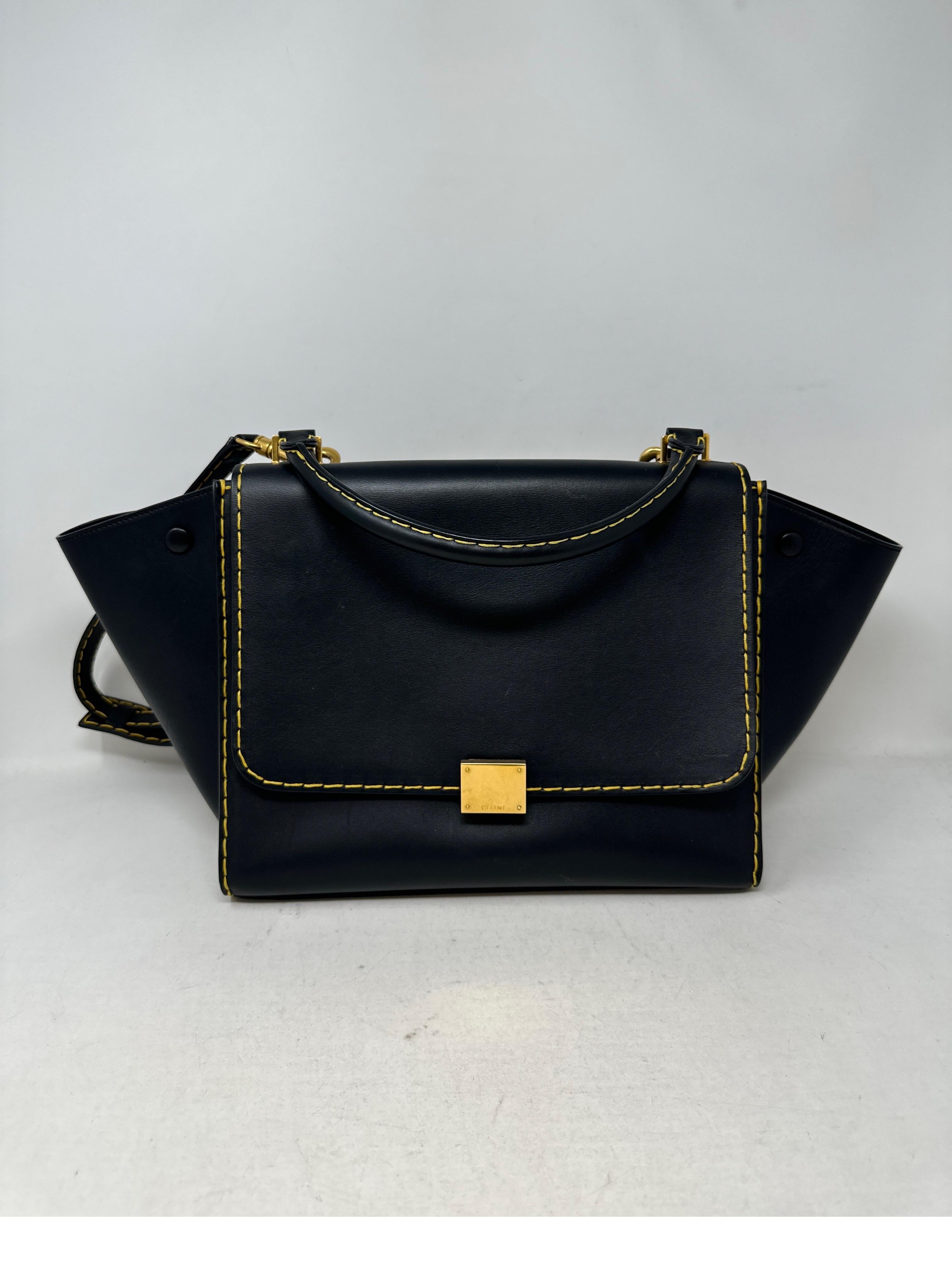 Celine Black Bag. Black leather with yellow contrast stitching. Excellent condition. Gold hardware. Interior clean. Unique style bag from Celine.