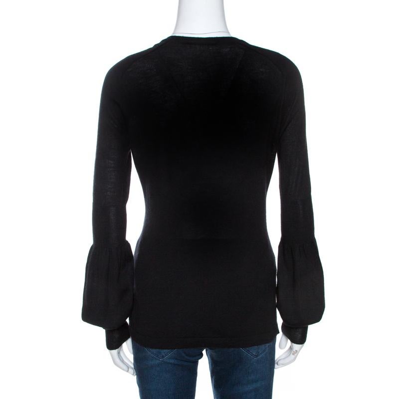 This stylish top from Celine will carry you through seasons effortlessly. It is classy, sophisticated and timeless. Crafted from 100% cashmere, it comes in black and is perfect for a host of occasions. It is styled with a v-neck and long sleeves