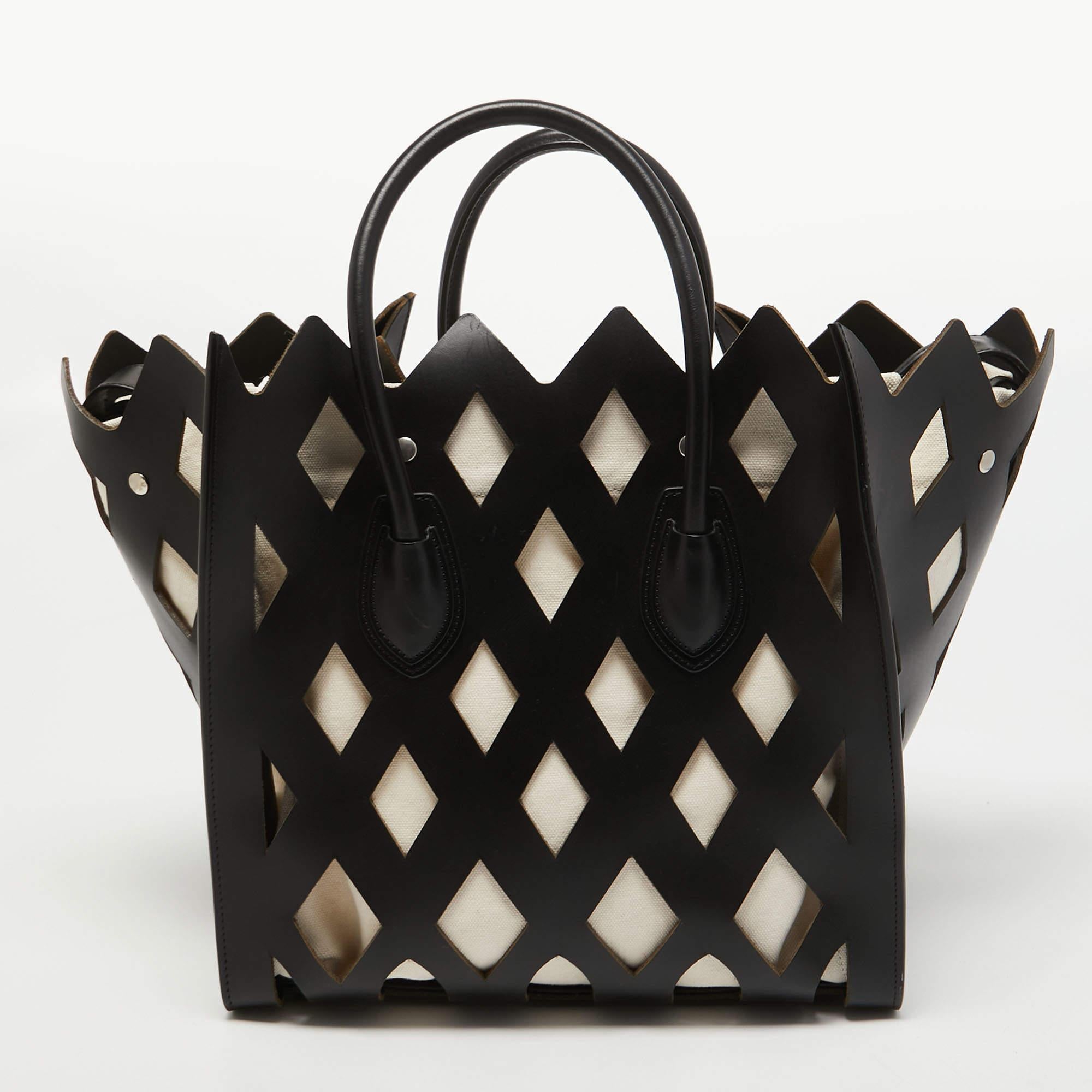 The house of Celine offers this beautiful creation to help you create timeless style edits every season. Crafted with leather and canvas, this authentic Celine tote will last you a long time.

Includes: Original Dustbag