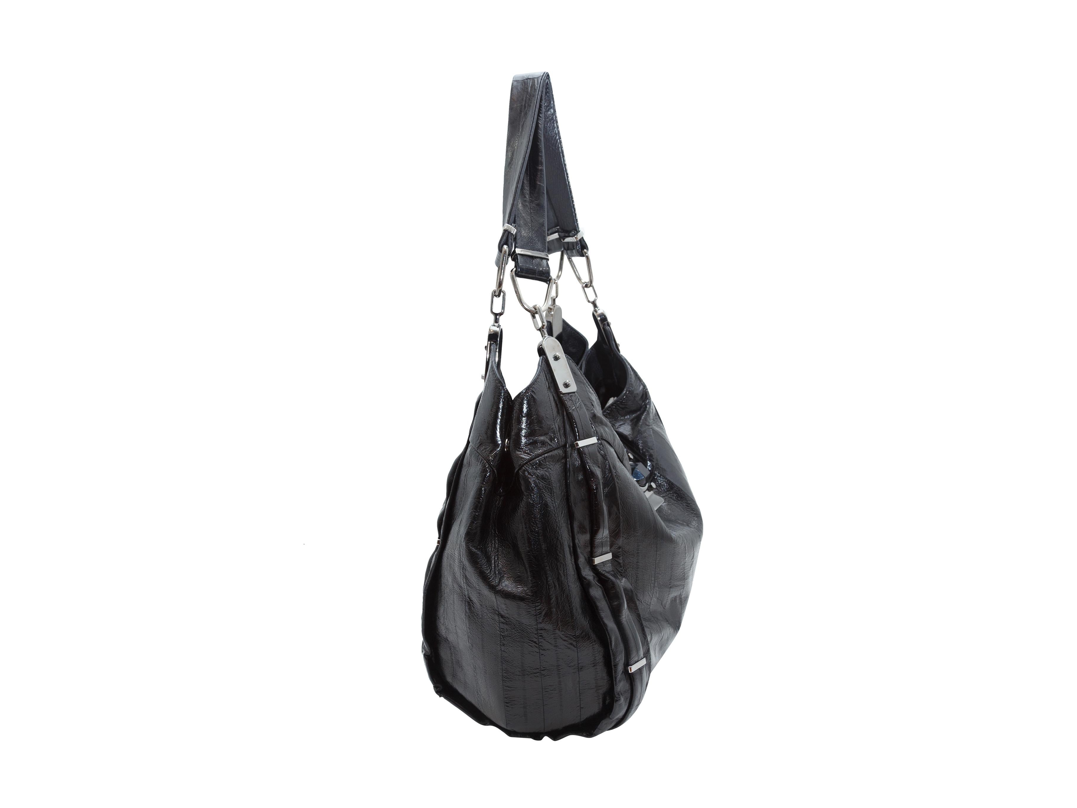 Product details: Black Celine Eelskin Shoulder Bag.  Buttery soft eelskin makes up the body of this Celine shoulder bag. It has flat eelskin straps, silver tone hardware, and a zippered interior compartment. 12