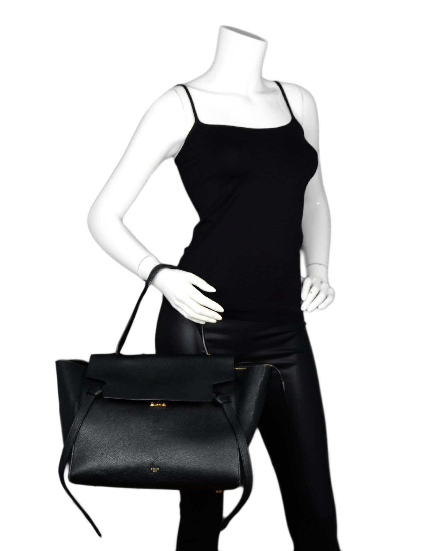Celine Black Grained Calfskin Leather Small Belt Bag

Made In: Italy
Color: Black
Hardware: Goldtone hardware
Materials: Grained calfskin leather
Lining: Black suede lining 
Closure/Opening: Top zip, top flap with magnetic snap
Exterior Pockets:
