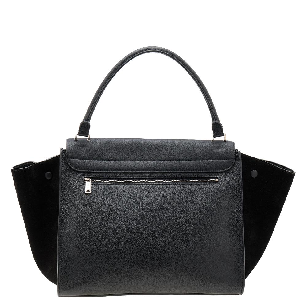In every stride, swing, and twirl, this beautiful Celine bag will stand out. Crafted from leather and suede in Italy, the bag is designed with signature flappy wings and a flap that reveals a spacious leather interior. A top handle makes the bag