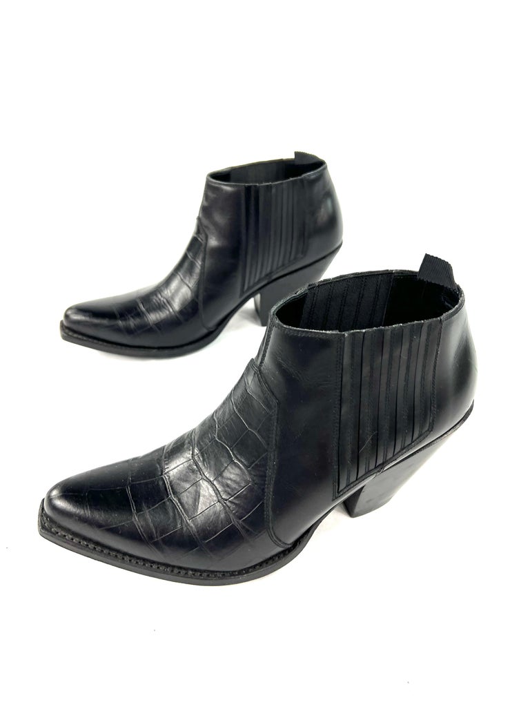 Product details:

The boots feature animal skin finish and ankle style with 3” heel height.