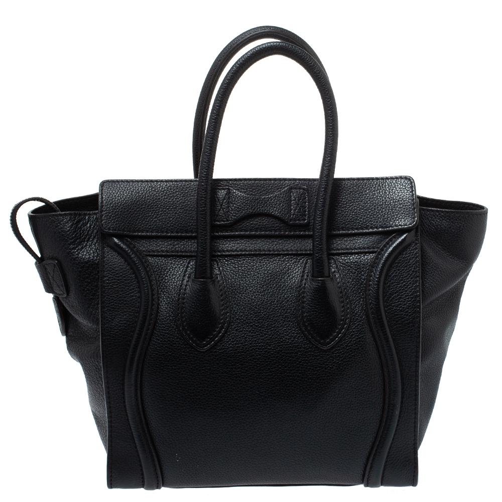 The Micro Luggage tote from Celine is one of the most popular handbags in the world. This tote is crafted from leather and designed in a black shade. It comes with rolled top handles and a front zip pocket. The bag is equipped with a well-sized