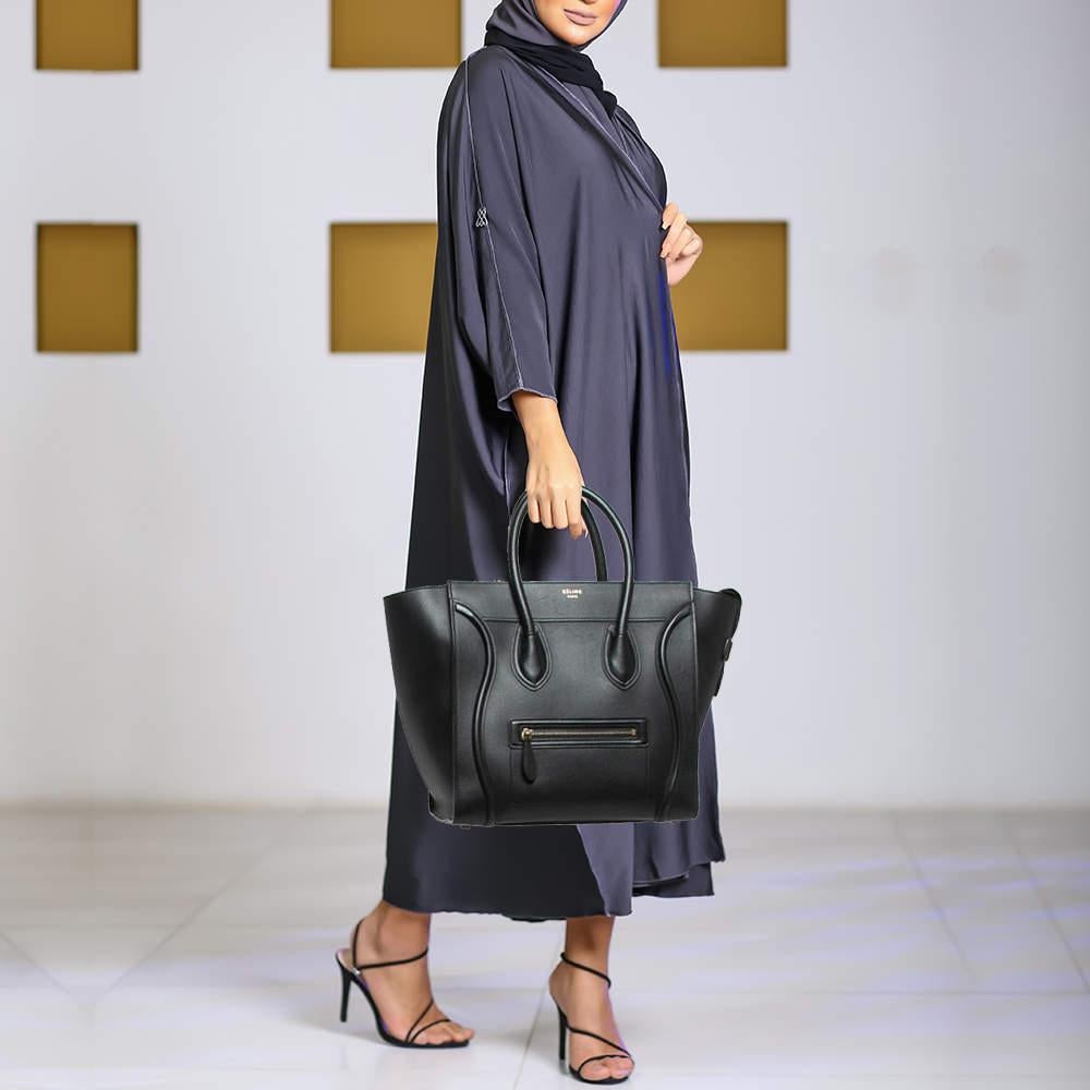The usage of black leather on the exterior gives this Celine tote a classy appeal. An eye catching accessory the bag features a front zipper pocket dual handles at the top and gold tone hardware. The lined interior is equipped to store more than