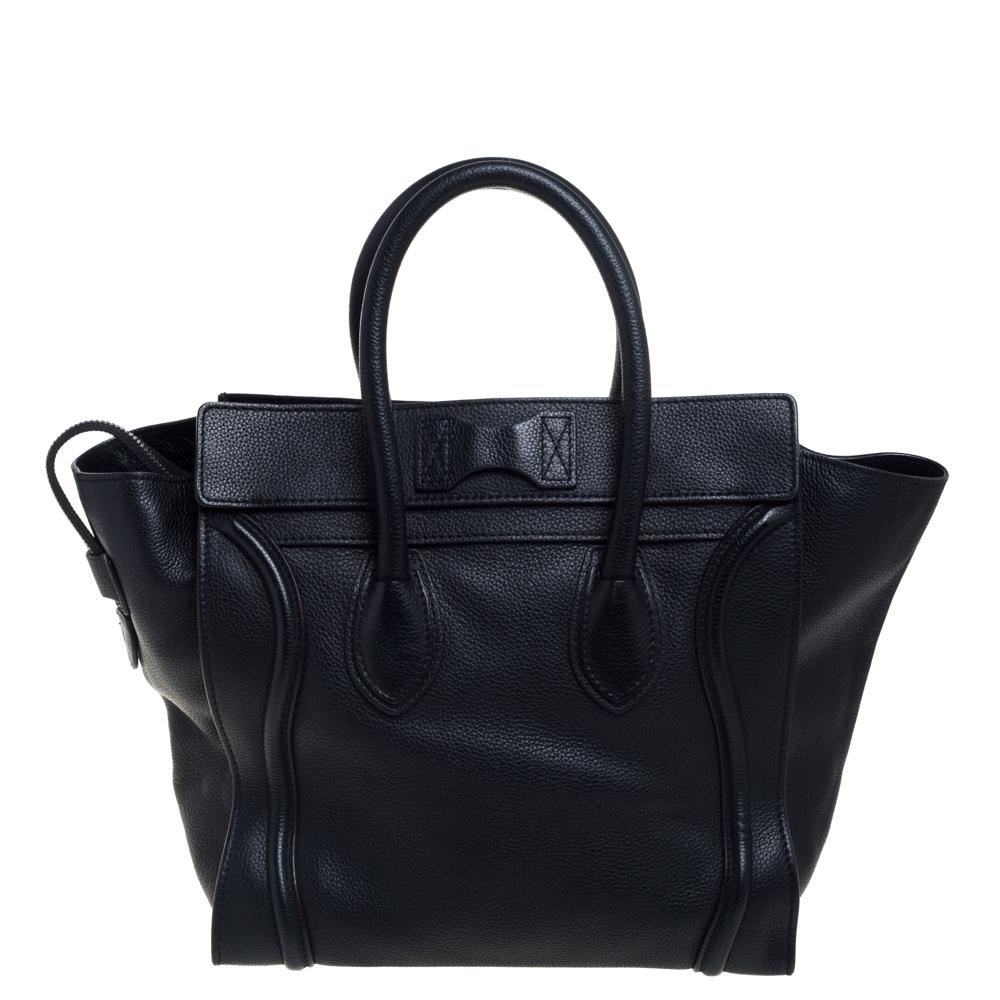 The mini Luggage tote from Celine is one of the most popular handbags in the world. This tote is crafted from leather and designed in a black shade. It comes with rolled top handles and a front zip pocket. The bag is equipped with a well-sized