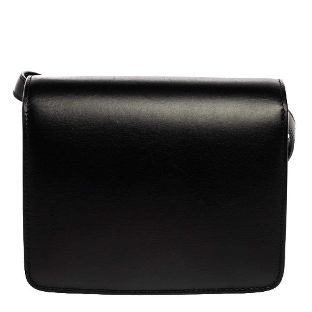 From the house of Celine comes this gorgeous Classic Box flap bag that will perfectly complement all your outfits. The black creation has been luxuriously crafted from quality leather and styled with a flap that opens to a well-sized leather-lined