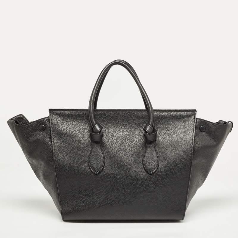 This Tie tote from Celine brings a wonderful mix of fashion and function. Expertly crafted from leather, it comes in a classy shade of black with dual knot-detailed handles and metal studs to protect the base. Made in Italy, it has a spacious