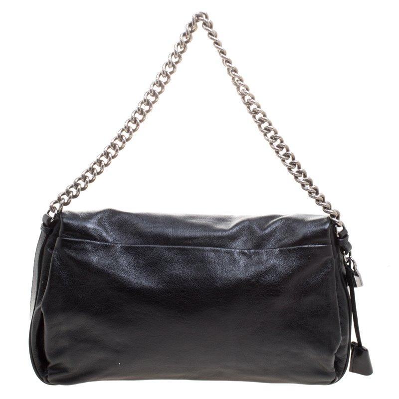 Every woman needs a bag that is pretty and functional, just like this shoulder bag from Celine. Crafted from leather, it has been styled with a flap leading to a spacious nylon interior and it is held by a chain handle. This is definitely one handy