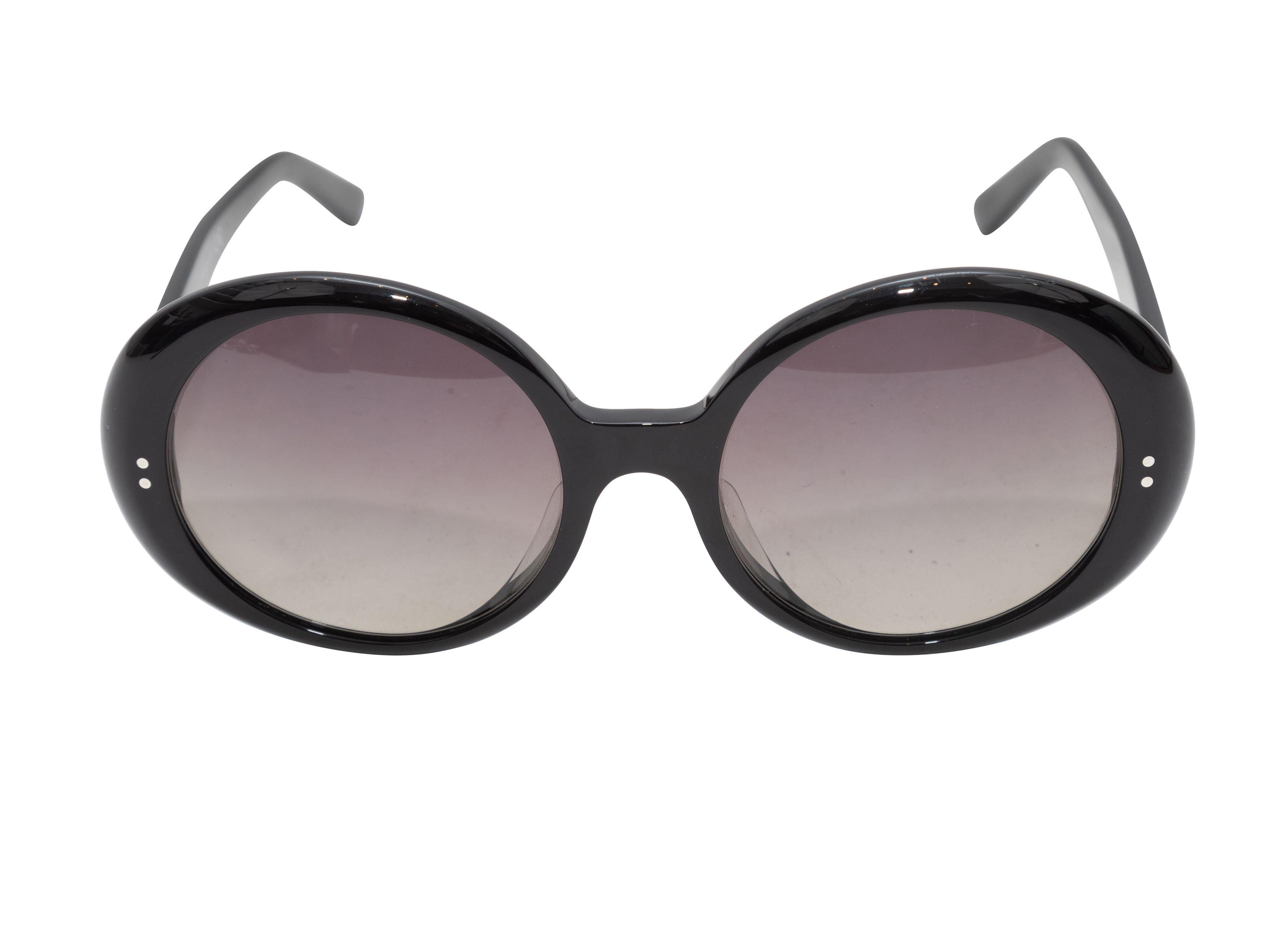 Product Details: Black oversize round acetate sunglasses by Celine. Grey tinted lenses. 2.5