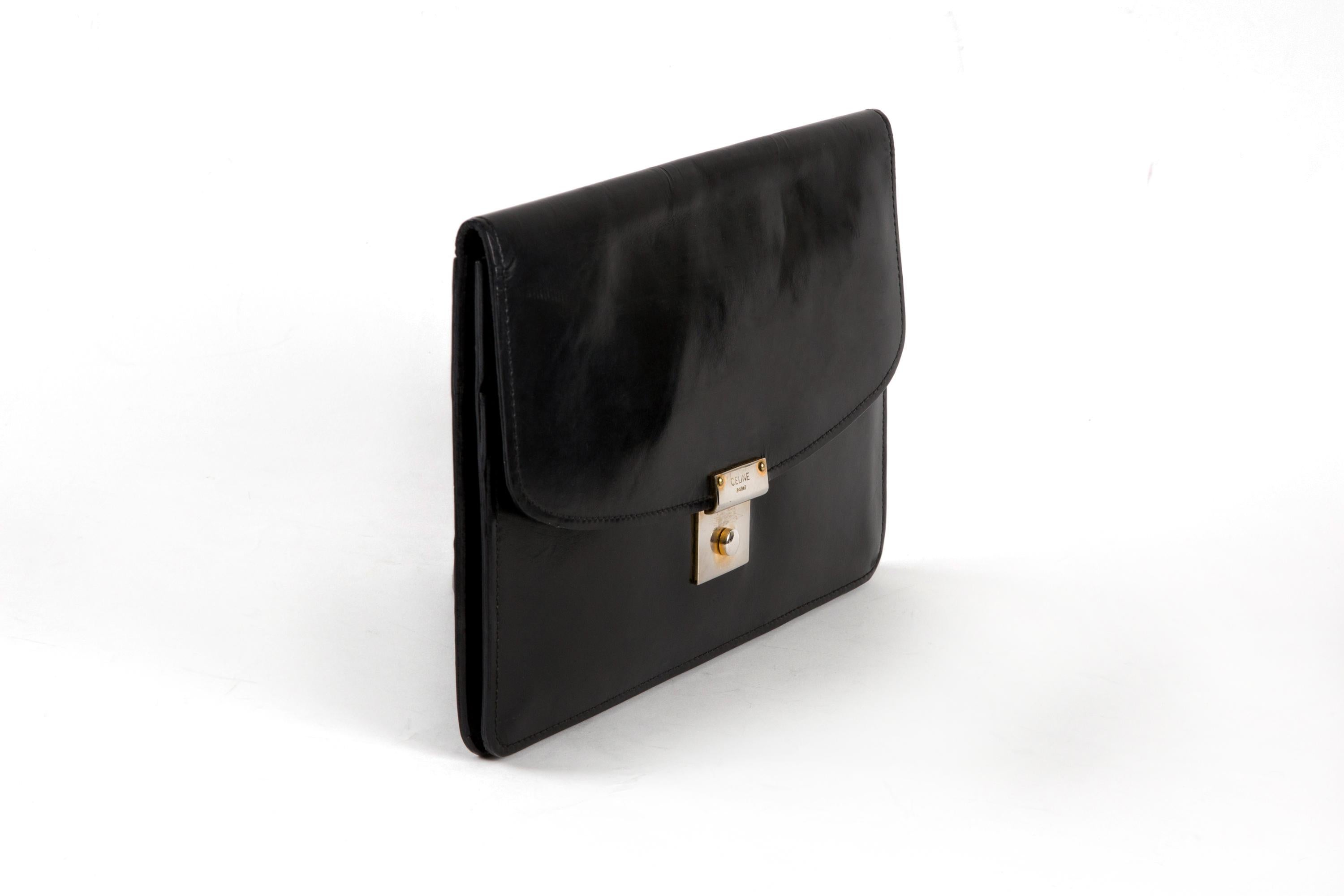 Celine Black leather  patent clutch featuring tarnish gold-tone hardware, inside compartments, a gold tone logo stamp. 
Circa 1970s. 
In good vintage condition. Made in France.
We guarantee you will receive this  iconic item as described and showed