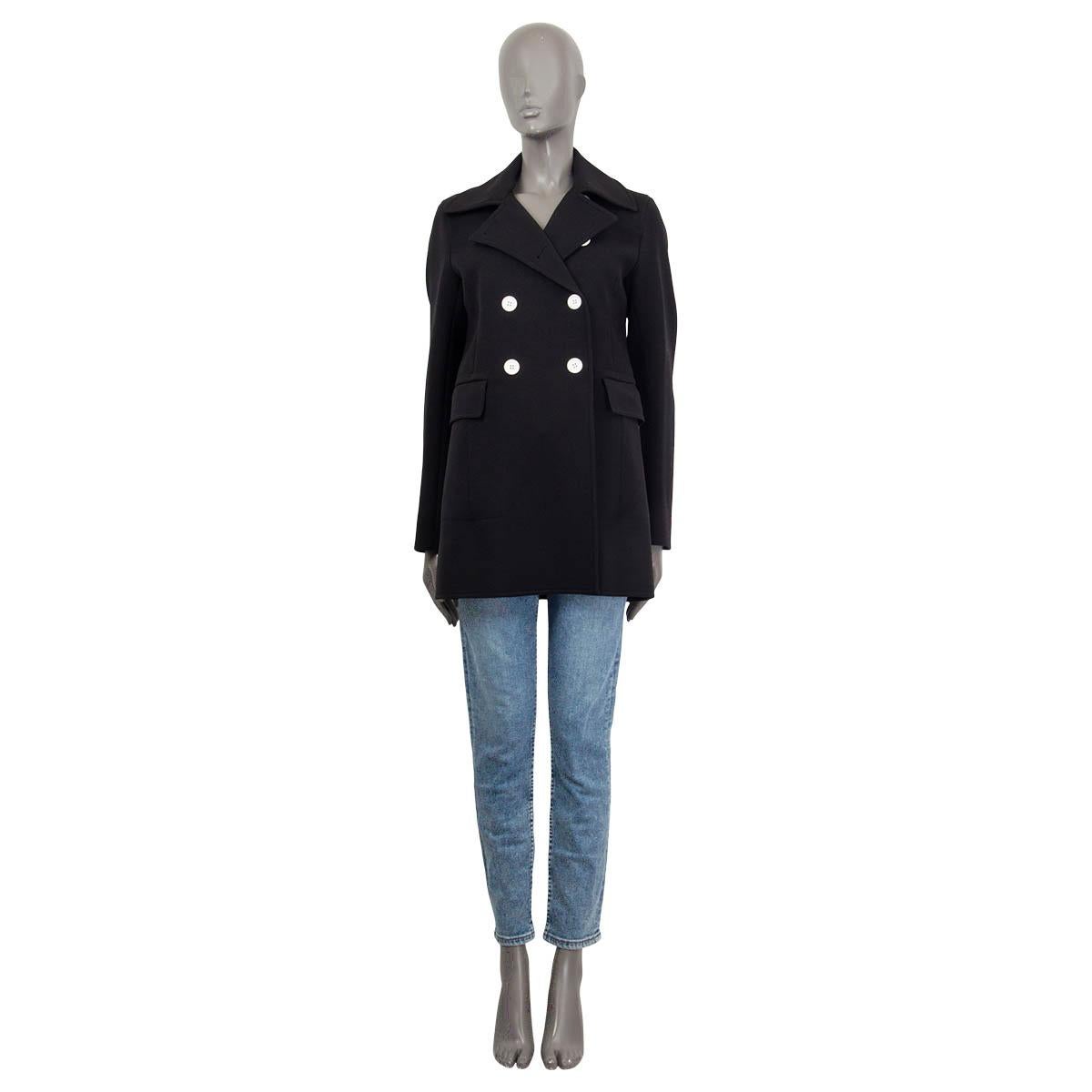 100% authentic Céline double breasted short coat in black polyamide (54%), virgin wool (45%) and elastane (1%). Features contrast buttons in white and two flap pockets on the front. Opens with six buttons on the front. Lined in black mulberry silk