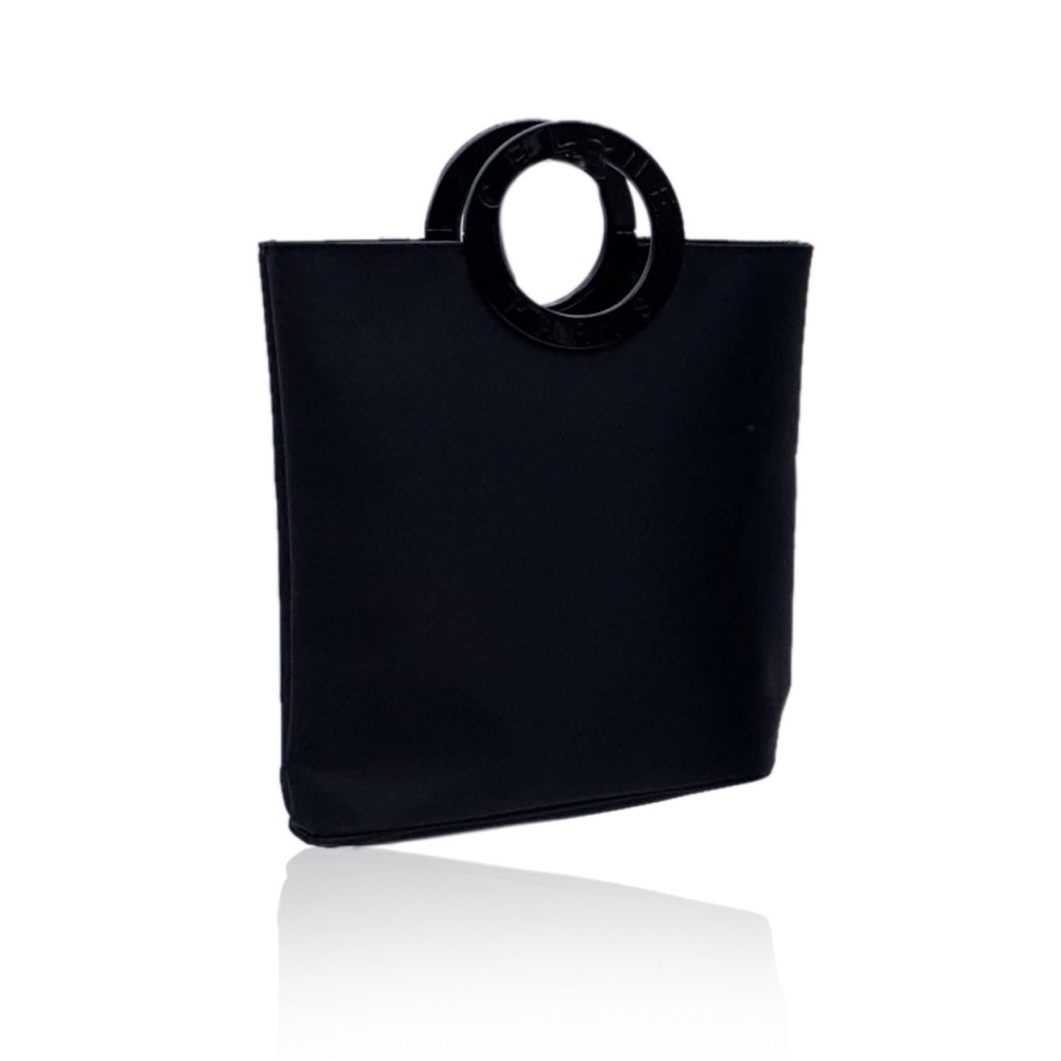 Celine black satin small tote with round plastic handles. 'Celine - Paris' engraved on handles. Open top. 1 side open pocket inside

Details

MATERIAL: Canvas

COLOR: Black

MODEL: -

GENDER: Women

COUNTRY OF MANUFACTURE: Italy

SIZE: Small

STYLE: