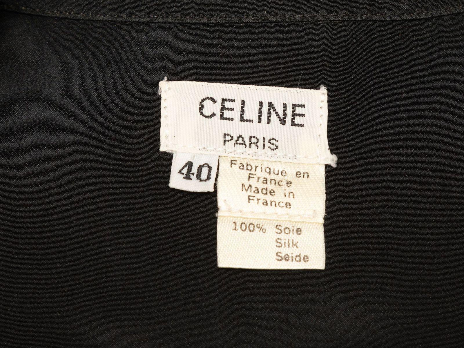 Product Details: Vintage black silk button-up top by Celine. Pointed collar. Long sleeves. Button closures at center front. Designer size 40. 36