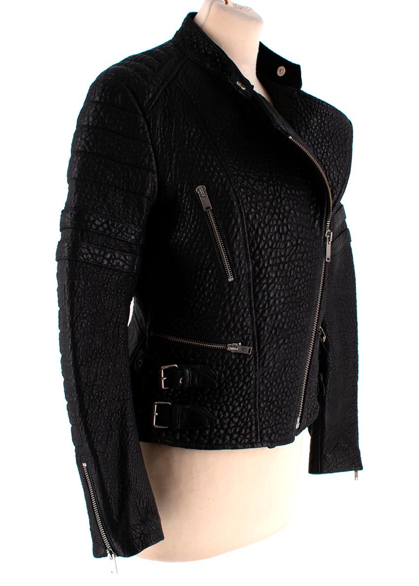 Celine Black Textured Lambskin Biker Jacket

- Celine by Phoebe Philo 
- Made of soft textured lambskin 
- Classic biker elements 
- Quilted panels to the sleeves 
- Buckle fastening to the sides 
- Pockets to the front 
- Quilted red lining 
- Zip