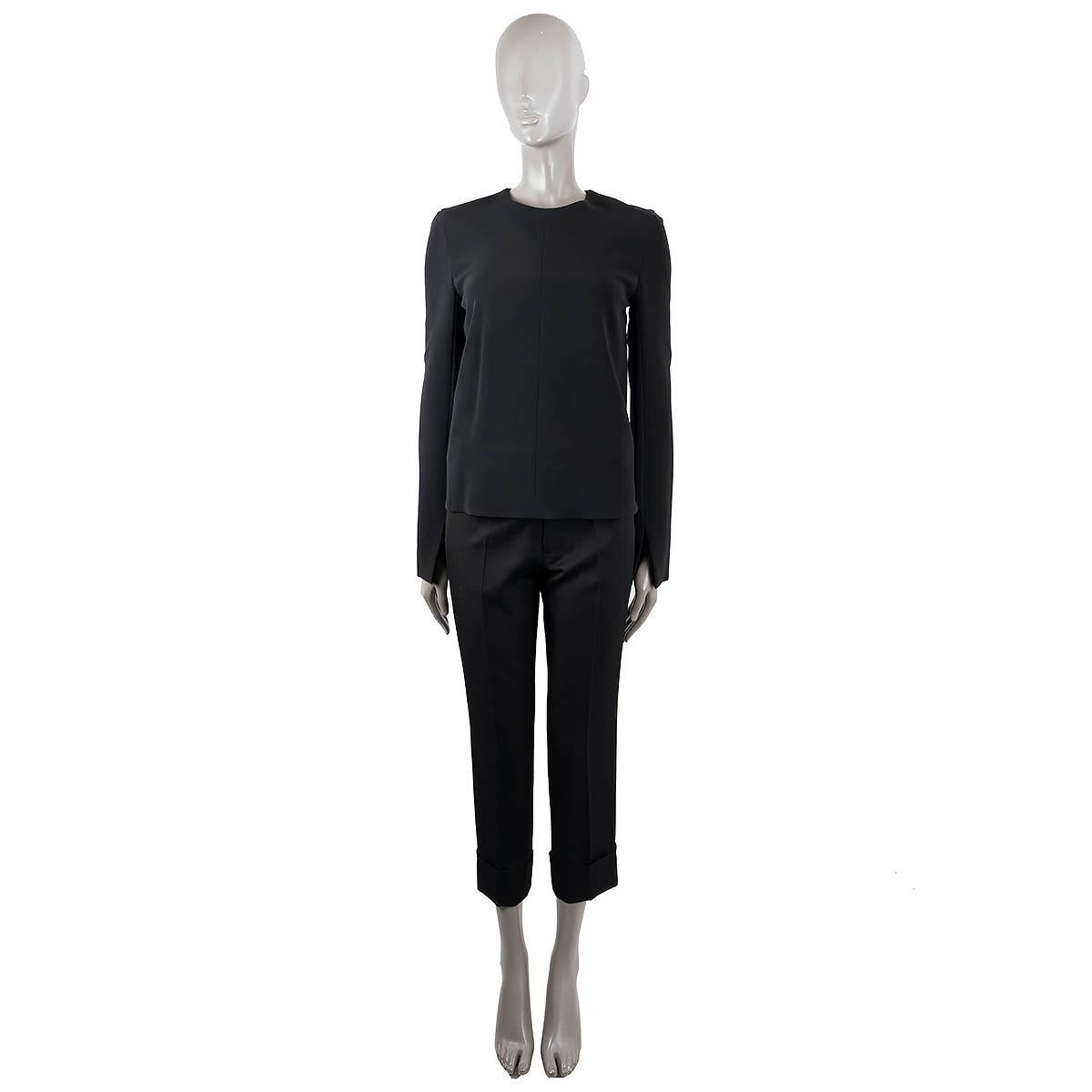 100% authentic Céline long sleeve Top in black viscose (50%), acetate (42%) and elastane (6%). Featured are two zipper in the back and split cuffs. Opens with a zipper in the back. Lined in silk (100%). Has been worn and is in excellent