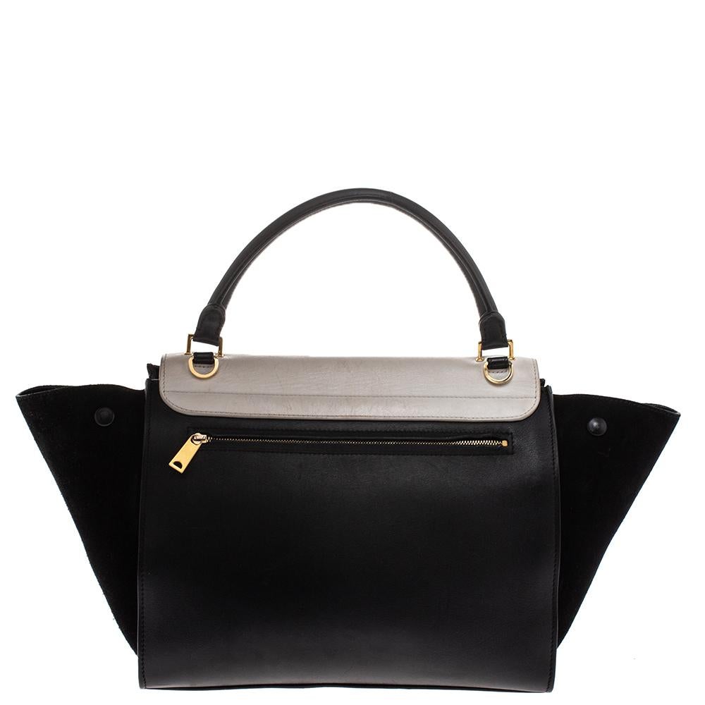 In every stride, swing, and twirl, your audience will gasp in admiration at the beautiful sight of this Celine bag. Crafted from quality leather and suede in Italy, this black & white bag has a style that will catch glances from a mile. It has been