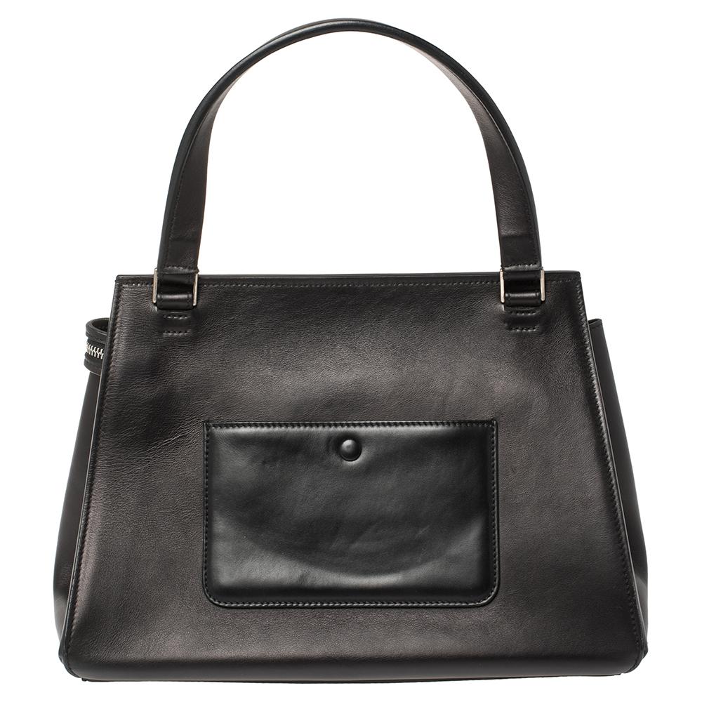This Celine Edge bag is not only visually magnificent but also functional. It has been crafted from leather and styled with a silhouette that is classy and posh. The back-white bag has a top handle and a top zipper that reveals a spacious interior.
