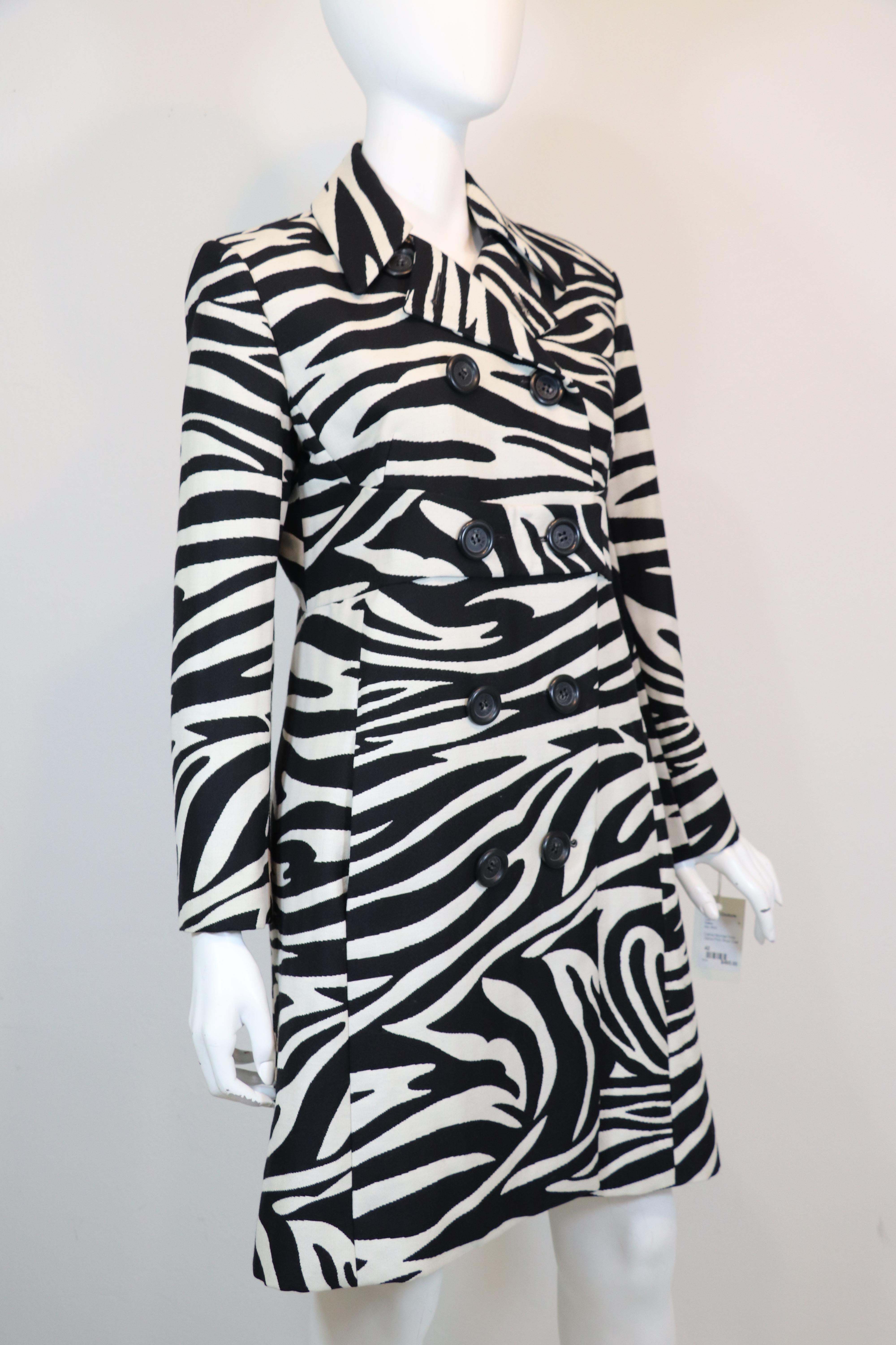 Celine structured wool coat in black and white zebra print with large black buttons, back half belt and two side pockets with a defined waist. Size 42 France. Made in France.
Bust: 39
