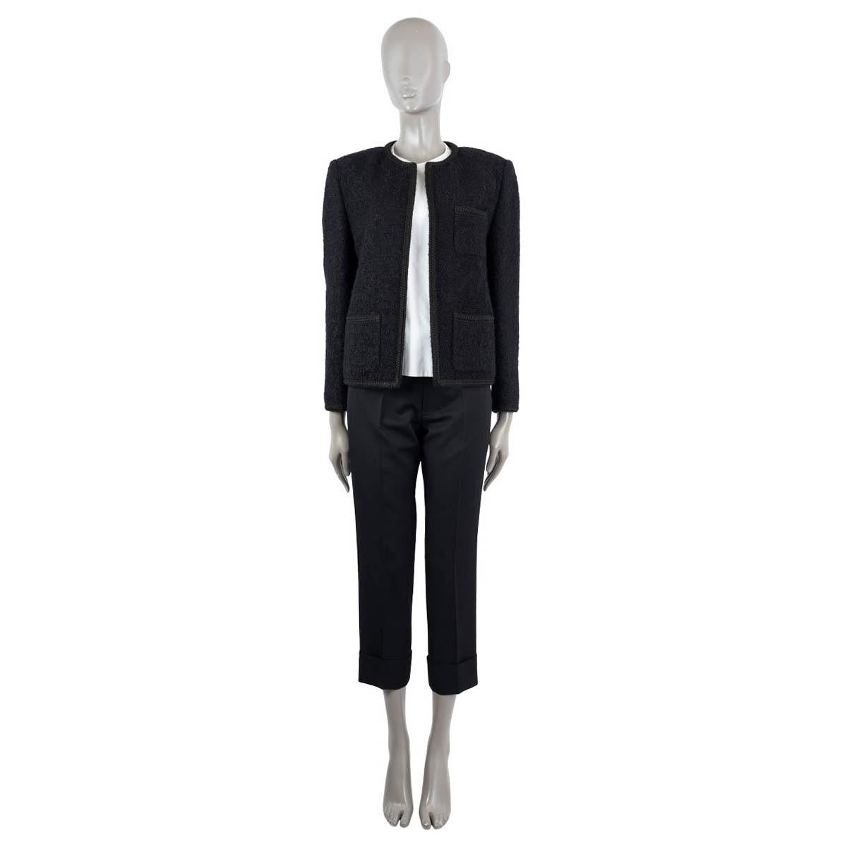100% authentic Celine Chasseur open tweed jacket in black wool (58%), mohair (35%) and polyamide (7%). Features three open pockets on the front and a braided trim. Lined in viscose (100%). Has been worn and is in excellent condition.

2020