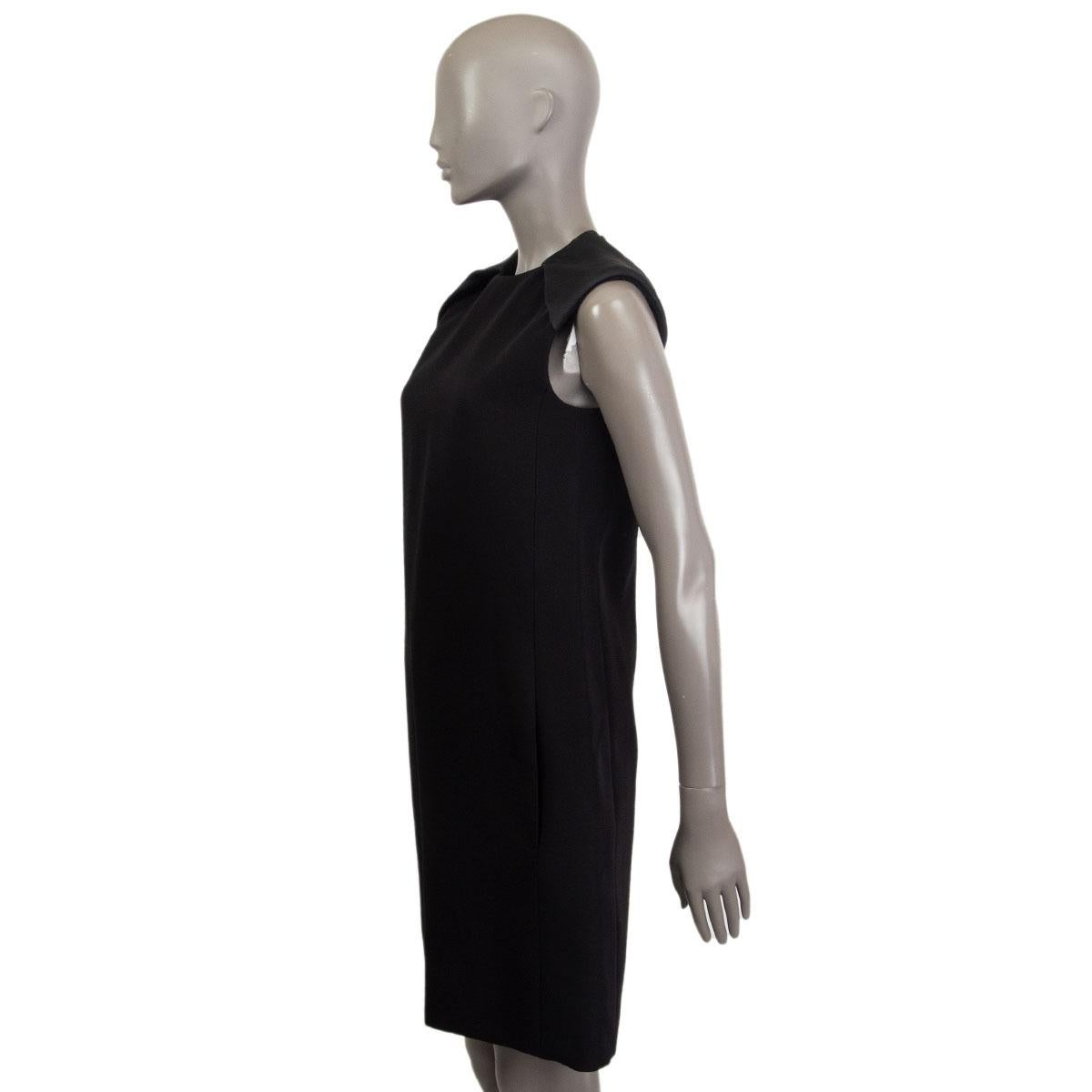 100% authentic Celine sleeveless A-Line dress in black wool (59%) and viscose (41%) with padded shoulders in black silk (100%) and slit pockets. Closes with one hook and a zipper on the back. Lined in black silk (100%). Has been worn and is in