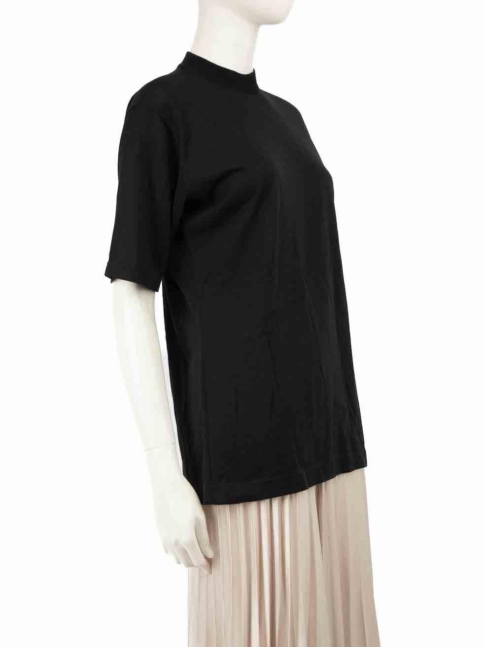 CONDITION is Good. Minor wear to top is evident. Light wear to the knit with a very small hole seen at the front of the neck on this used Céline designer resale item.
 
 
 
 Details
 
 
 Black
 
 Wool
 
 Top
 
 Short sleeves
 
 Mock neck
 
 Logo