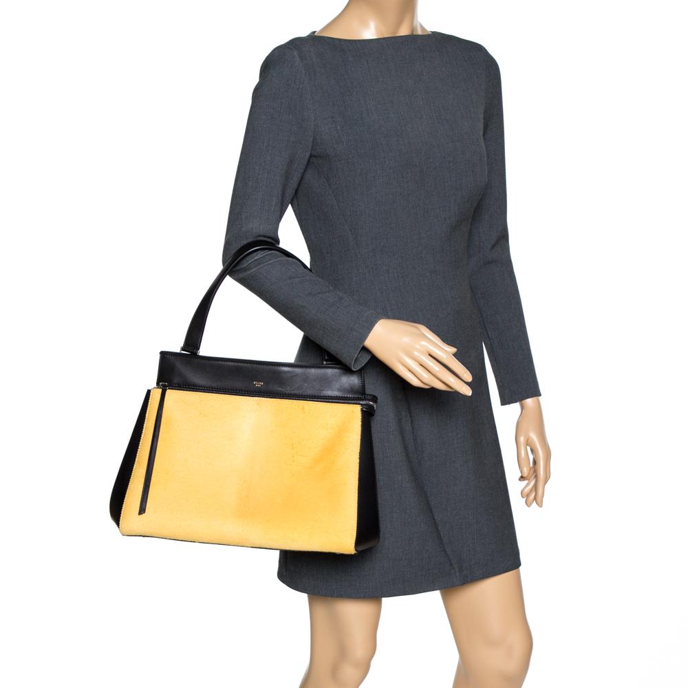 This Celine Edge bag is not only visually magnificent but also functional. It has been crafted from calfhair and leather and styled with a silhouette that is classy and posh. 