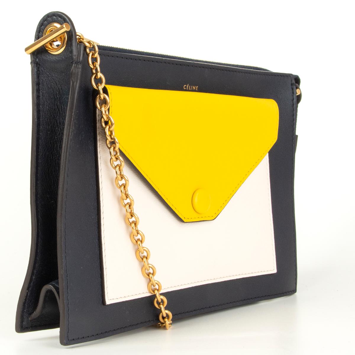 Céline 'Pocket Medium Chain' shoulder bag/clutch in midnight blue, yellow and off-white calfskin. Opens with a zipper on top and is lined in midnight blue calfskin. Comes with a detachable shoulder strap. Has been carried and the yellow flap has two