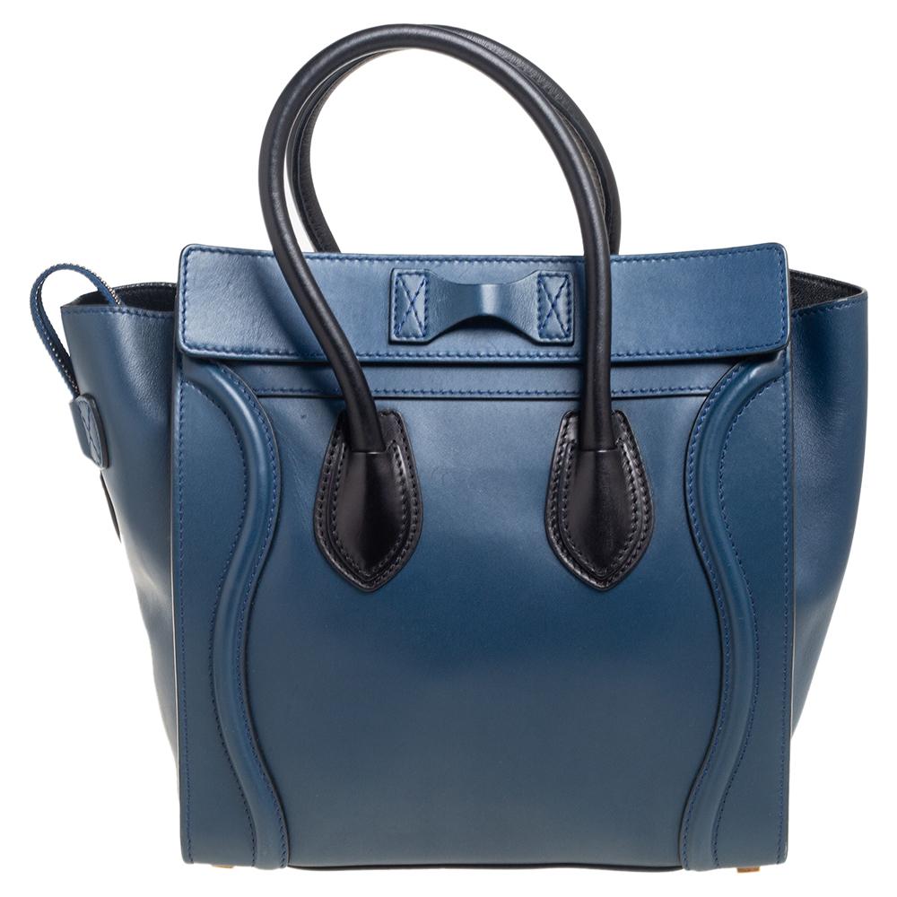 The Luggage tote from Celine is one of the most popular handbags in the world. This tote is crafted from leather and designed in black and blue colors. It comes with rolled top handles and a front zip pocket. The bag is equipped with a well-sized